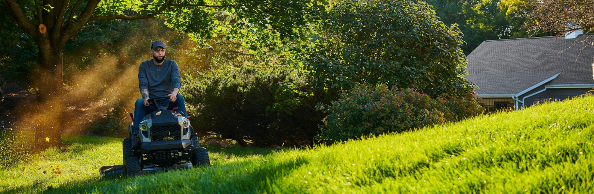 A person riding a Briggs and Stratton-powered Murray Lawn Mower.