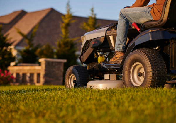 Man on a Murray riding mower powered by a Briggs & Stratton engine. 