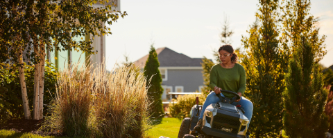 A person riding a Briggs and Stratton-powered Murray Lawn Mower.